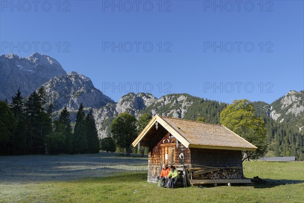 Hikers resting wooden hut