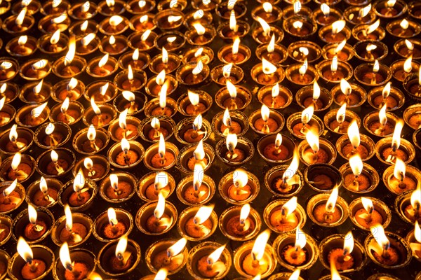 Many luminescent prayer candles inside Swayambhunath temple