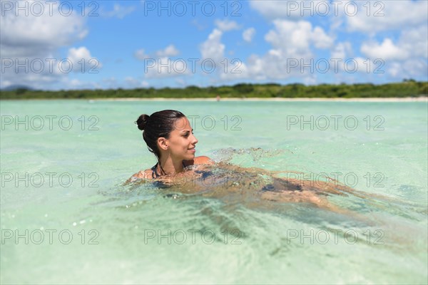 Young woman swimming in water