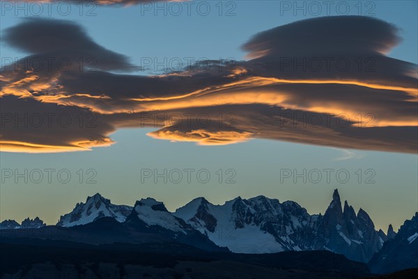 Lenticularis clouds over Fitz Roy summit massif with snow