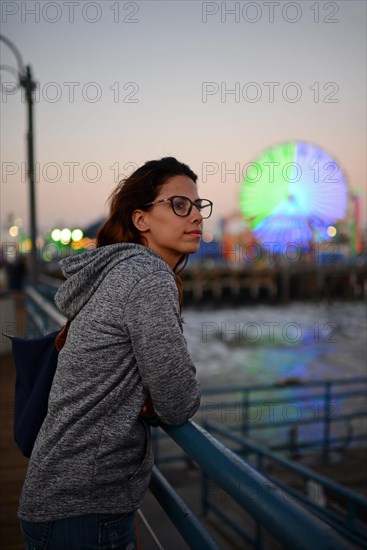 Attractive young woman relaxing on pier