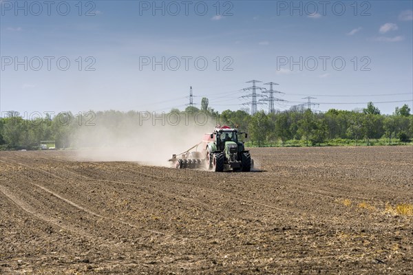 Agricultural landscape with a tractor ploughing a field