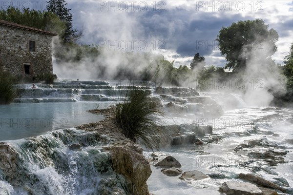 Steam is arising from the hot springs of Saturnia Therme in the morning