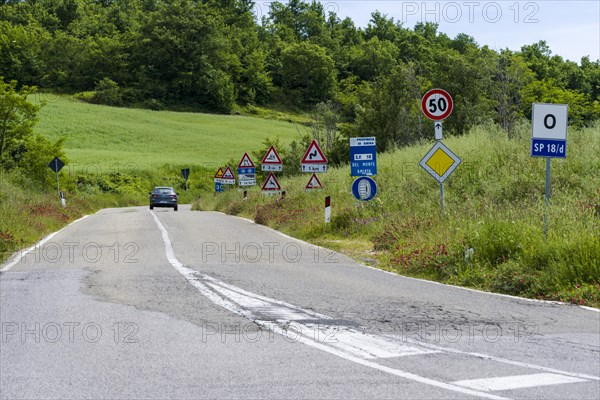 Road flanked bei many traffic signs
