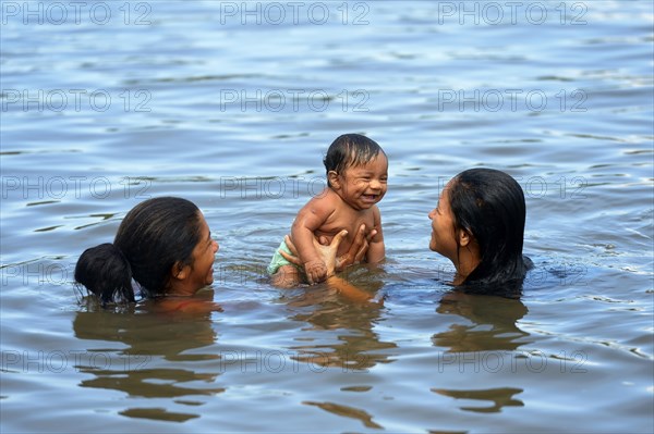 Woman with baby in the river Rio Tapajos