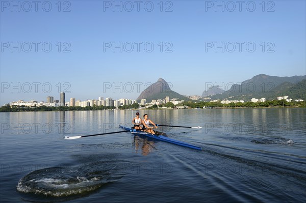 Two young women participating in early morning rowing training in the Lagoa Rodrigo de Freitas Lagoon