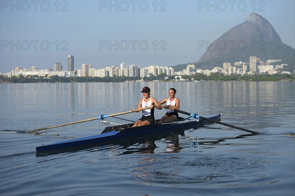 Two young women participating in early morning rowing training in the Lagoa Rodrigo de Freitas Lagoon