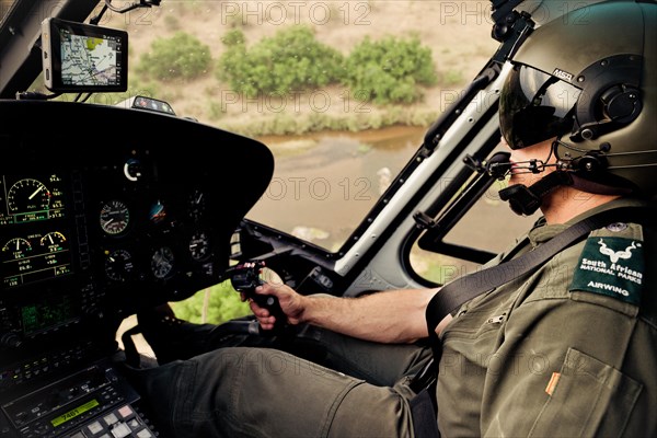 Helicopter pilot monitors poaching