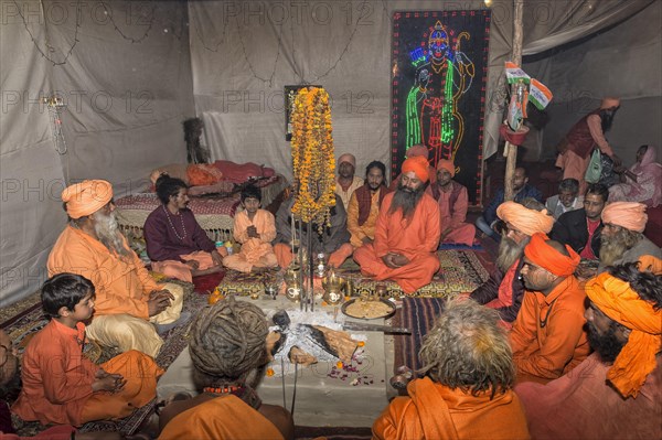 Pilgrims gathered and meditating in a tent