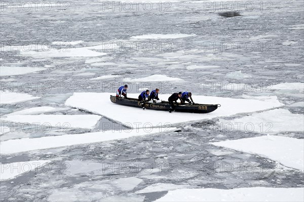 Canoe race challenge over the partly frozen Saint Lawrence River