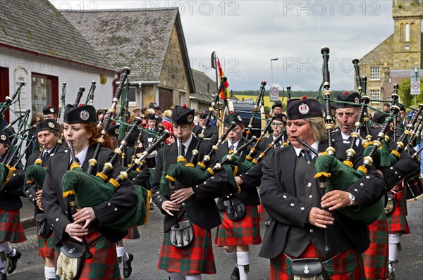 Bagpipers playing instruments in a parade