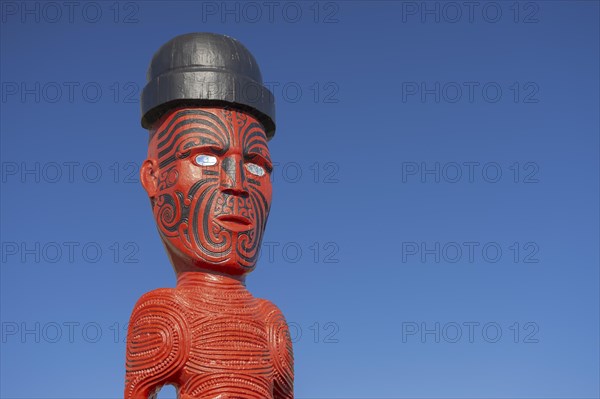 Artfully carved traditional statue of Maori made of wood