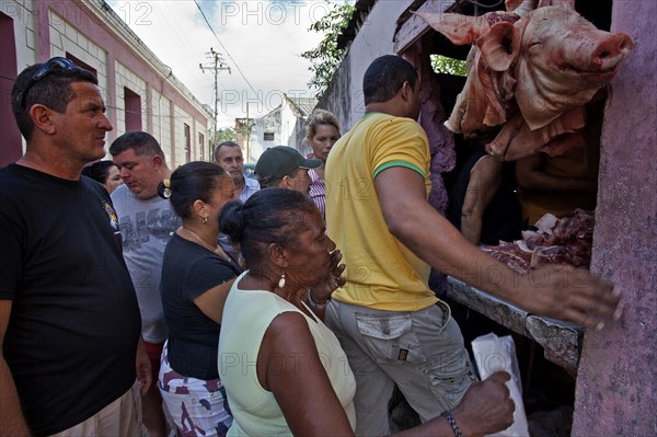 Locals at a sales stand with meat