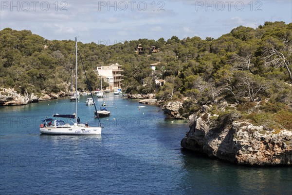 Sailboats anchor in the bay of Cala Figuera