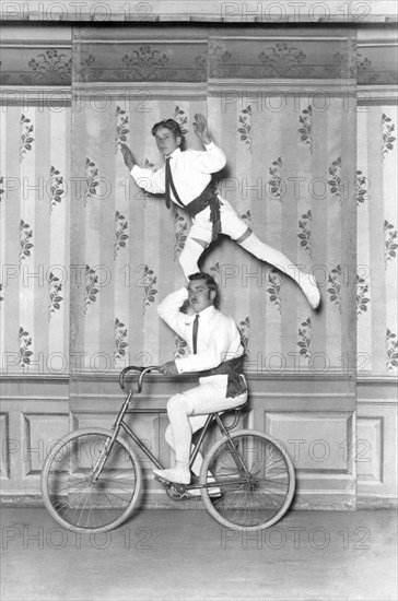 Two acrobats on a bicycle