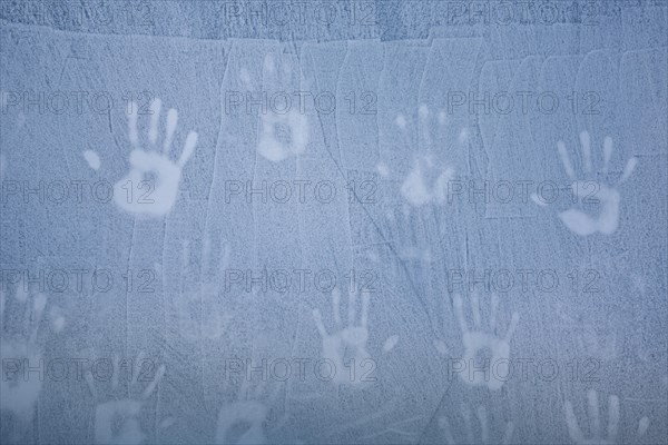 Handprints on ice wall