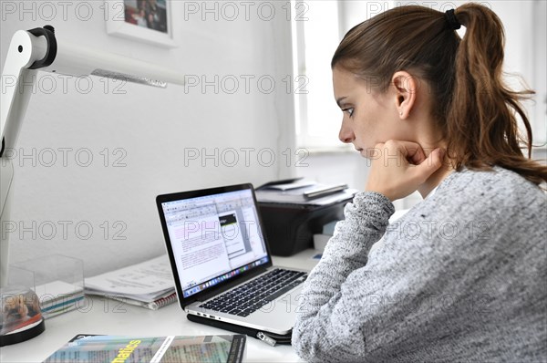 Student at desk with a laptop