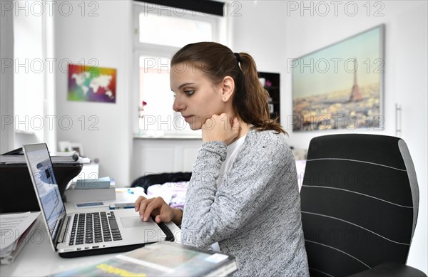 Student at desk with a laptop