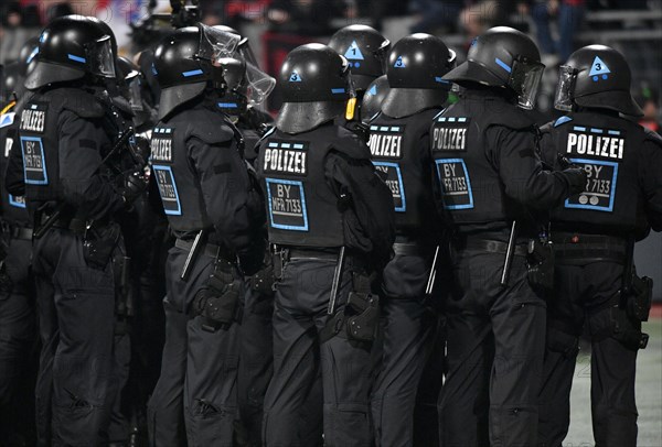 Riot police in uniform in front of fans