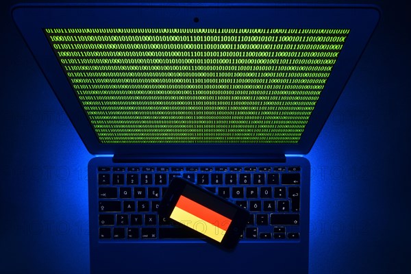 Smartphone with German flag on computer keyboard