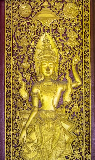 Ornate golden panel at Wat Wisunalat