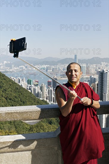 Buddhist monk takes a selfie with selfie stick