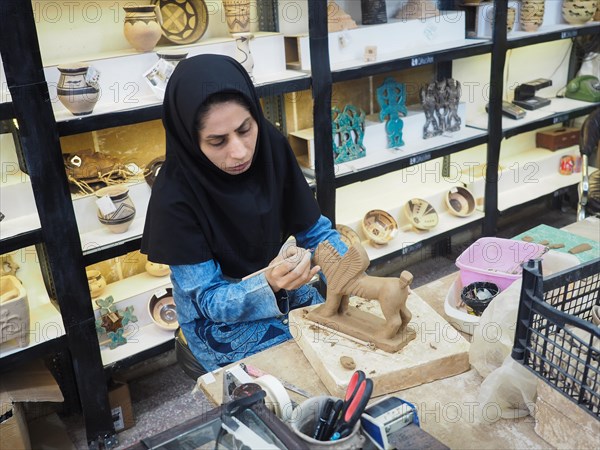 Potter working on clay figure