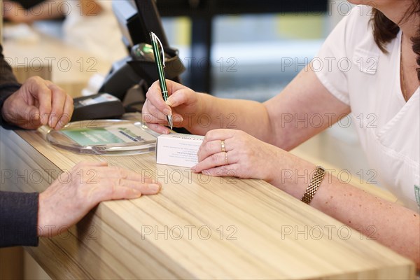 Pharmacist with customer in the pharmacy