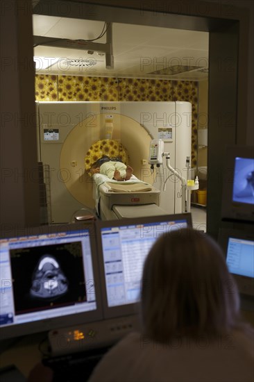 Doctor monitors patient on monitor at CT