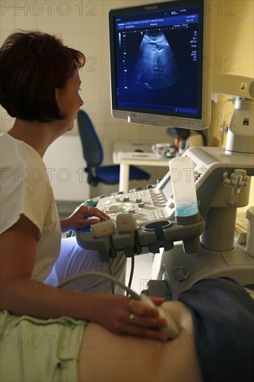 Nurse at the monitor with patient at ultrasound