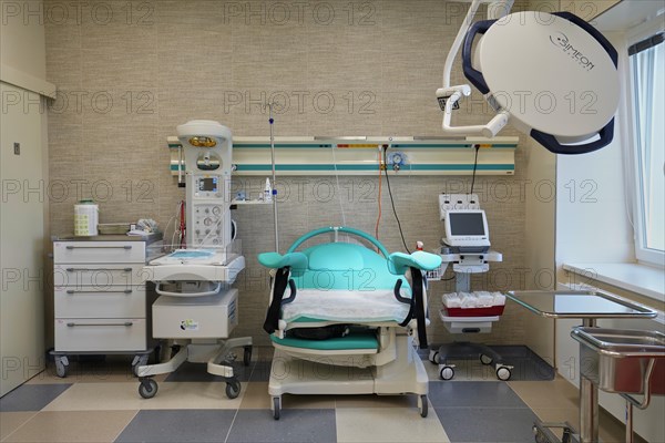 Empty modern delivery room with birthing chair