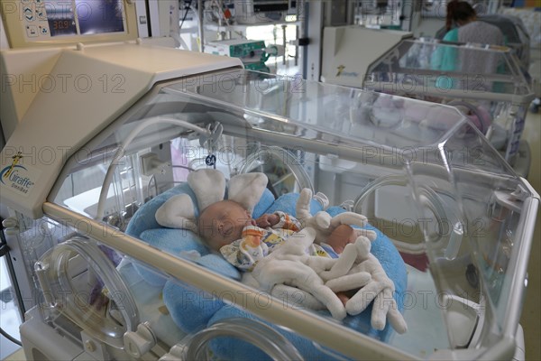 Newborn in incubator