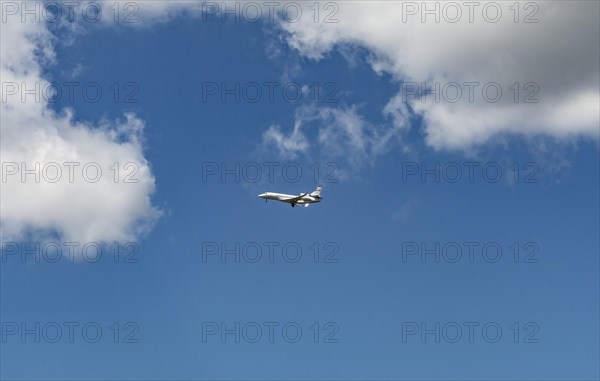 Business Jet flying in front of a blue cloudy sky