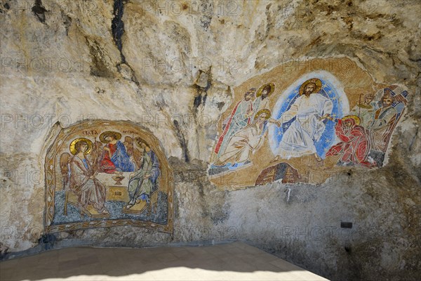 Religious mosaics on rock face