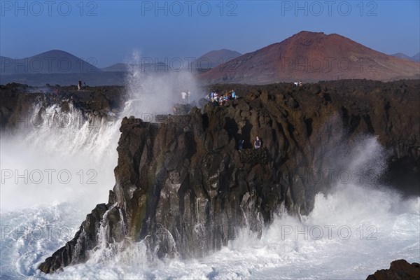 Surf with spray on rocky coast