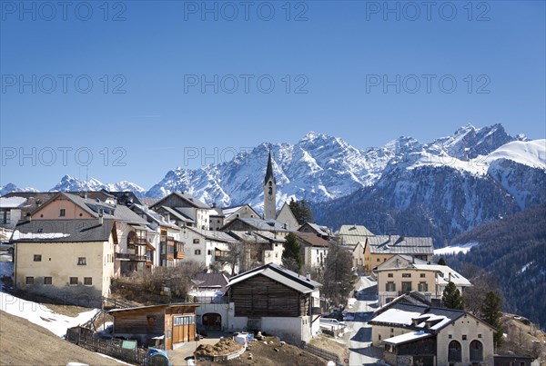 Mountain village Guarda in front of snowy mountains