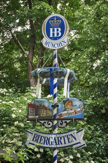 Sign beer garden in front of trees