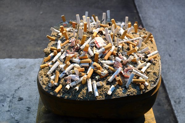 Ashtray with cigarette butts at Skytrain Station