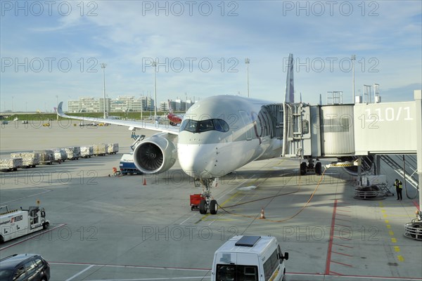 Airbus A350 with passenger boarding bridge