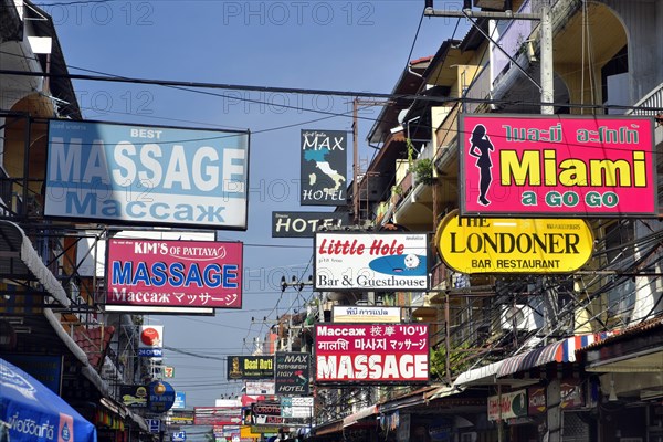 Many colorful advertising signs in pedestrian zone