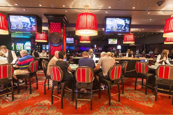 Poker players at poker table in casino