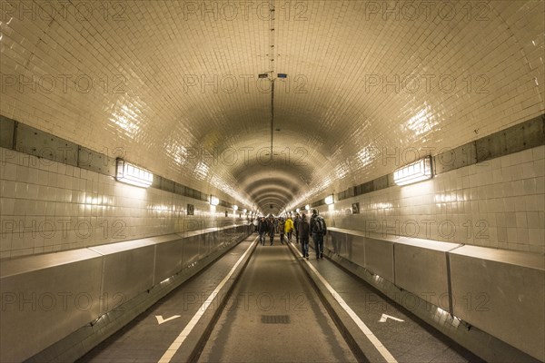 Pedestrians walk through the old Elbe tunnel