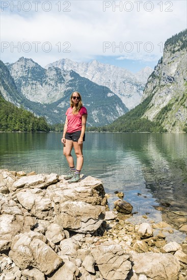 Hiker stands on the shore of the Obersee