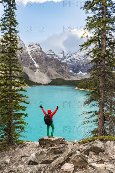 Hiker stands on the shore of a lake