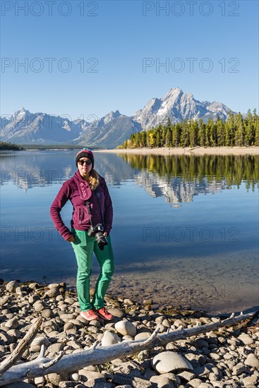 Young woman standing on the shore looking into the camera