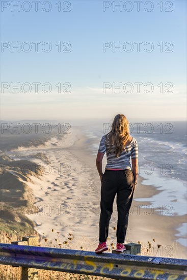 Young woman looking into the distance at a viewpoint