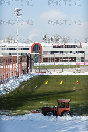 Snowplough clears snow at the football pitch