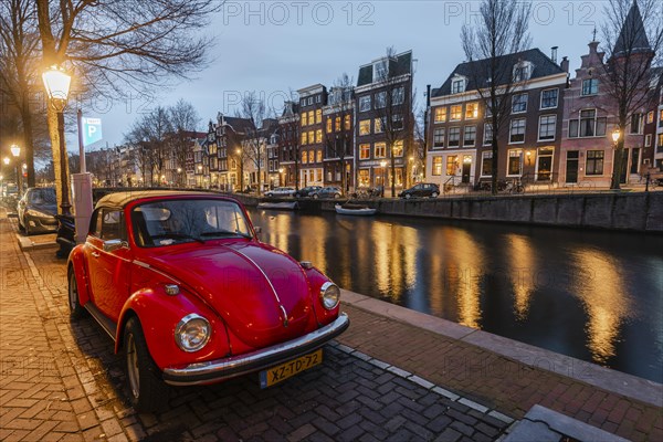 Old VW Beetle parks at the canal
