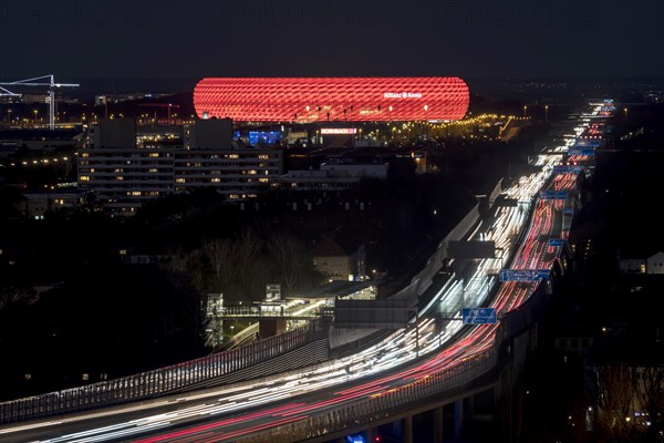 Red lit Allianz Arena at A9 motorway