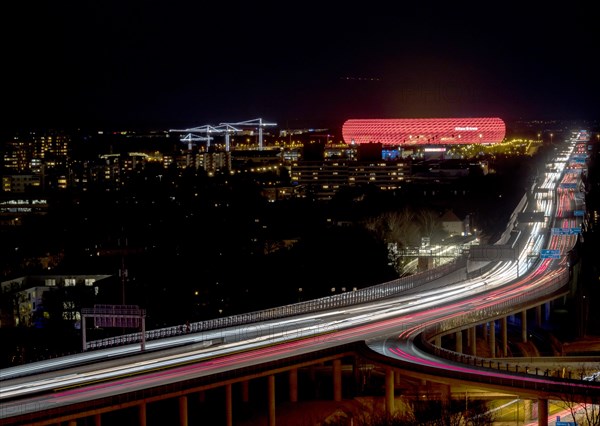 Red lit Allianz Arena at A9 motorway